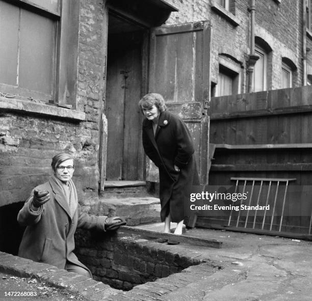 British author Colin Wilson ascending the steps of a cellar during a visit to the East End of London, February 25th, 1960.