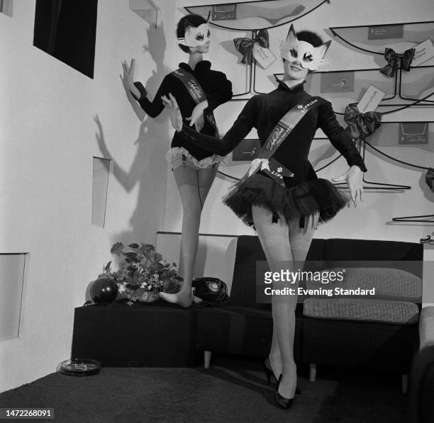 Fashion model in a cat mask and tutu models Taylor-Woods' Nine-Lives Nylons stockings at a Nylon Trades Fair at the Royal Albert Hall, London,...