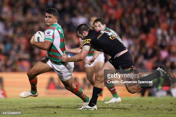 Latrell Mitchell of the Rabbitohs Is tackled by Isaah Yeo of the Panthers during the round two NRL match between the Penrith Panthers and the South...