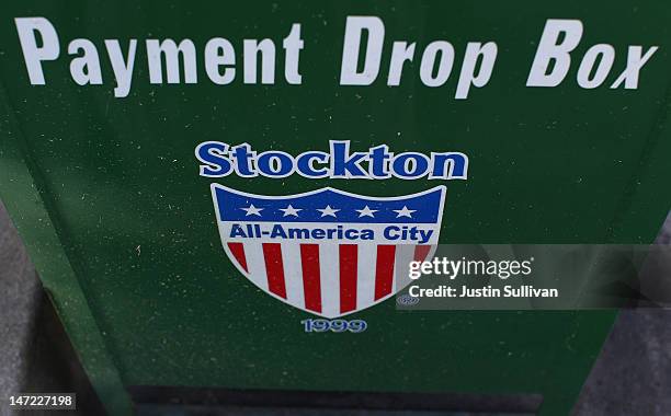Sign is posted on the side of a utility bill payment box outside of Stockton City Hall on June 27, 2012 in Stockton, California. Members of the...