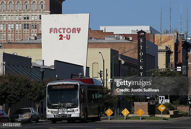 Bus drives by a sign on June 27, 2012 in Stockton, California. Members of the Stockton city council voted 6-1 on Tuesday to adopt a spending plan for...