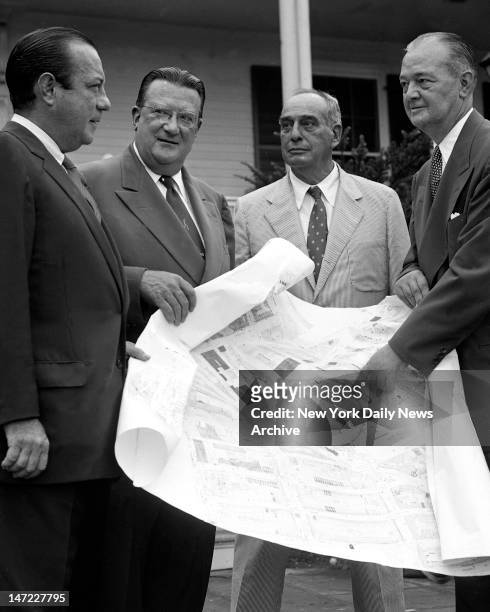 Outside Gracie Mansion, Mayor Robert Wagner, Walter O'Malley and Robert Moses look on as Brooklyn Borough President John Cashmore points out spot on...