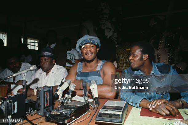 Heavyweight boxing champion George Foreman holds a press conference in Kinshasa, Zaire, on September 18th, 1974. His trainer Sandy Saddler is seated...