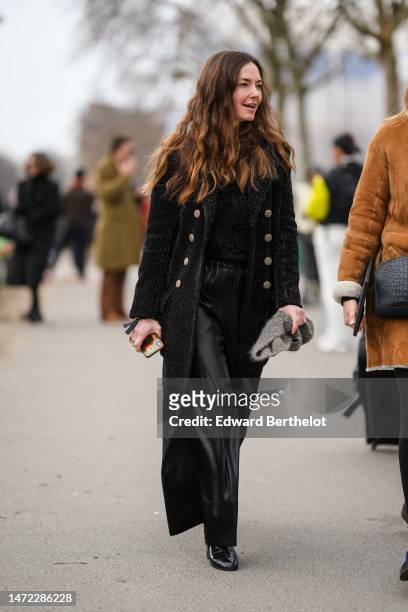 Guest wears a black fluffy pullover, a black fluffy long coat, black shiny leather large pants, a gray wool scarf, black shiny leather heels ankle...