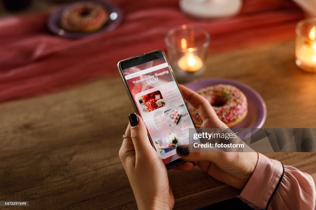 Young woman shopping sales online during Valentine's day