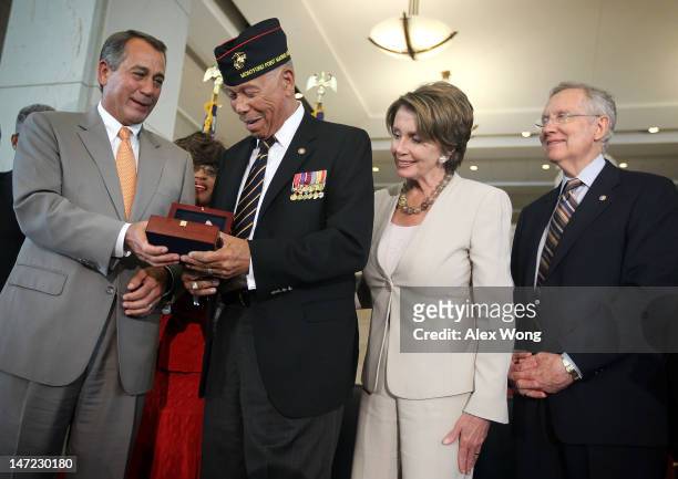 William McDowell , a representative of the Montford Point Marines, receives the Congressional Gold Medal from U.S. Speaker of the House Rep. John...