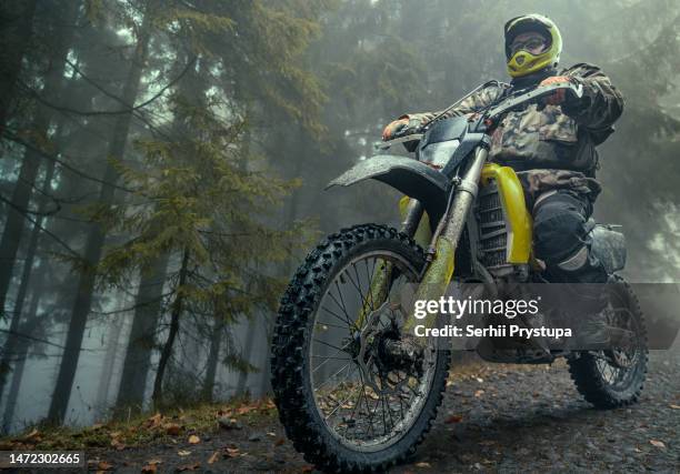 man rides on dirt bike - route moto stock pictures, royalty-free photos & images