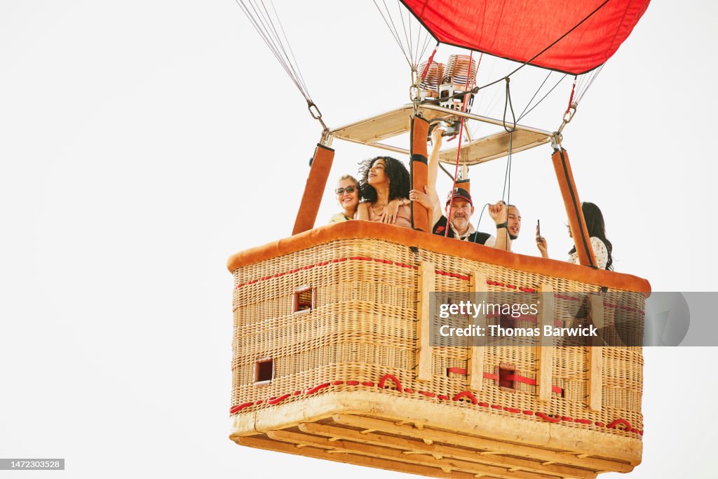 Wide shot of family and friends on early morning hot air balloon ride