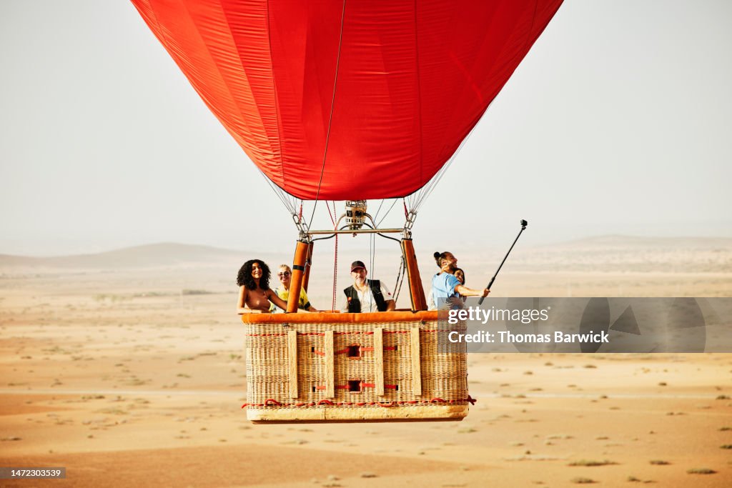 Wide shot of family and friends on early morning hot air balloon ride
