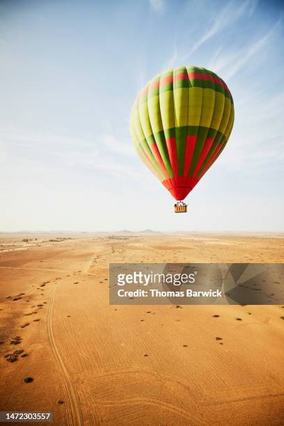 extreme wide shot hot air balloon on trip over the deserts of morocco - hot air balloon ride stock pictures, royalty-free photos & images