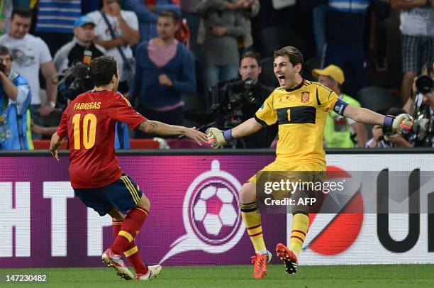 Spanish midfielder Cesc Fabregas and Spanish goalkeeper Iker Casillas celebrate after winning the Euro 2012 football championships semi-final match...