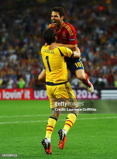 Cesc Fabregas celebrates scoring the winning penalty with Iker Casillas of Spain during the UEFA EURO 2012 semi final match between Portugal and...