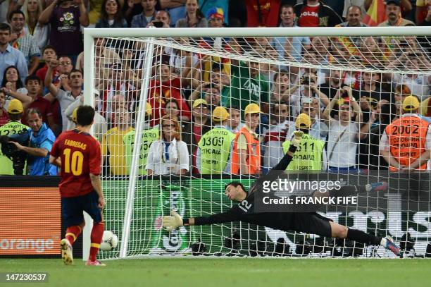 Spanish midfielder Cesc Fabregas scores the winning penalty despite Portuguese goalkeeper Rui Patricio during the penalty shoot out of the Euro 2012...