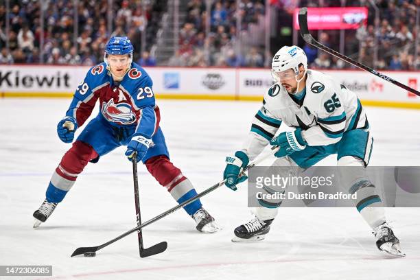 Nathan MacKinnon of the Colorado Avalanche breaks up a play by Erik Karlsson of the San Jose Sharks in a game at Ball Arena on March 7, 2023 in...