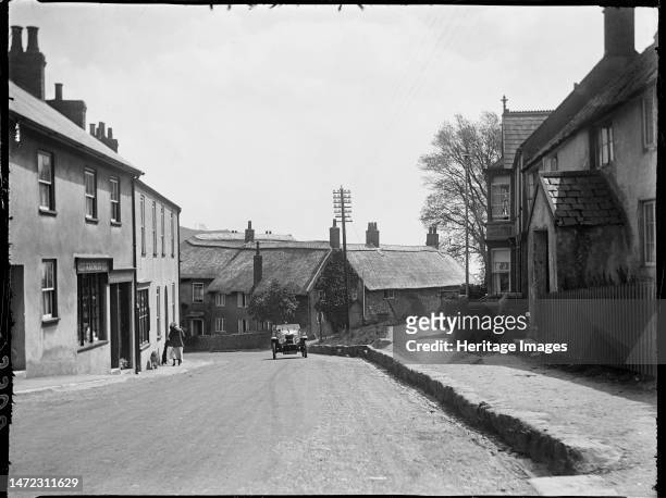The Street, Charmouth, West Dorset, Dorset, 1925. A view of The Street from the Axminster Road end, looking towards thatched cottages at the junction...