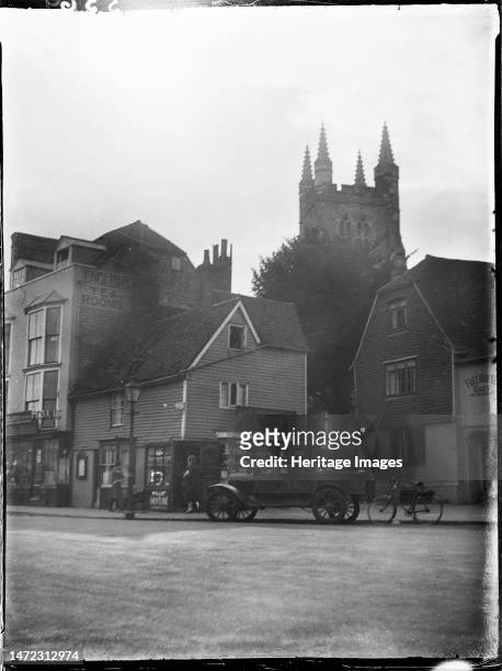 High Street, Tenterden, Ashford, Kent, 1926. A view of the tower of St Mildred's Church from south-east on the High Street, with number 28 High...