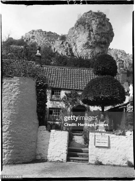 Lily Cottage, Cliff Road, Cheddar, Sedgemoor, Somerset, 1907. Mrs Main standing in the front garden of Lily Cottage with the house behind her and...