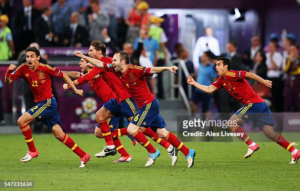 Jesus Navas, Sergio Ramos and Andres Iniesta of Spain celebrate the winning penalty during the UEFA EURO 2012 semi final match between Portugal and...