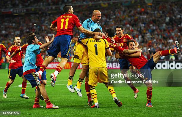 Cesc Fabregas of Spain celebrates scoring the winning penalty with team-mates during the UEFA EURO 2012 semi final match between Portugal and Spain...