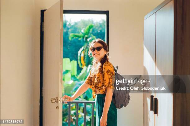 woman standing in doorway to tropical paradise - walking away from camera stock pictures, royalty-free photos & images