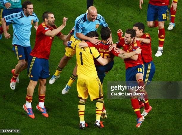 Cesc Fabregas of Spain celebrates scoring the winning penalty with team-mates during the UEFA EURO 2012 semi final match between Portugal and Spain...
