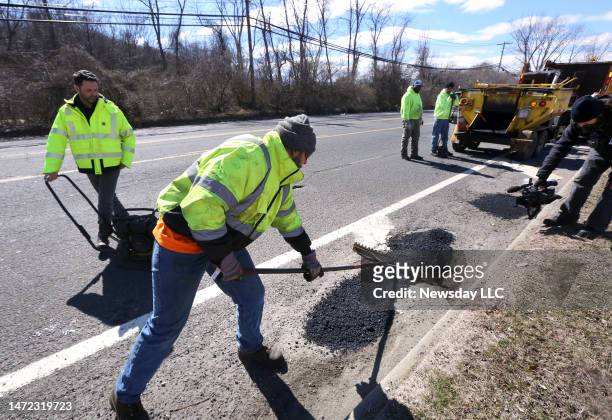 Town of Huntington crews demonstrate how they do pot holes repairs along Spagnoli Road, in Melville, New York, on March 8 in an effort to educate the...