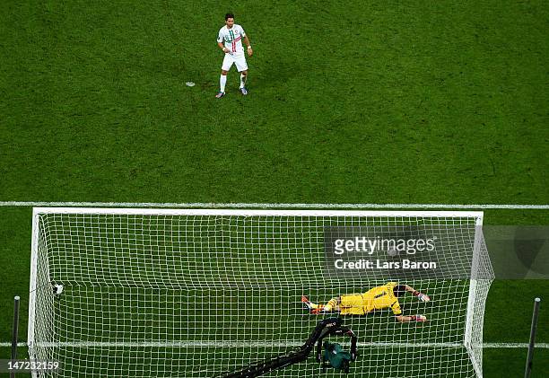 Iker Casillas of Spain saves a penalty from Joao Moutinho of Portugalduring the UEFA EURO 2012 semi final match between Portugal and Spain at Donbass...