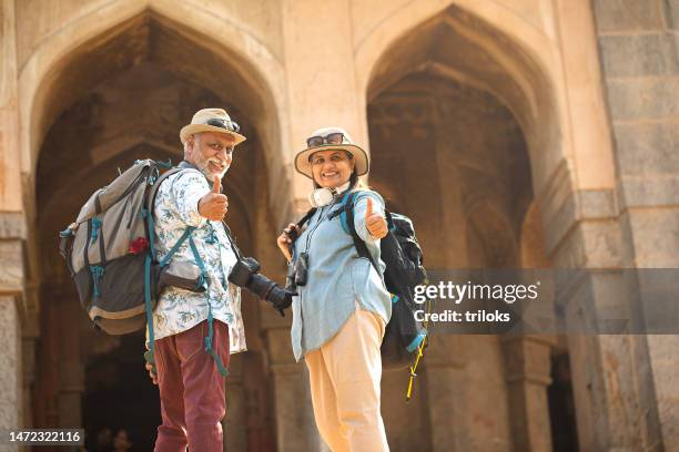 senior couple giving thumbs up during vacation post retirement - ok sign stock pictures, royalty-free photos & images
