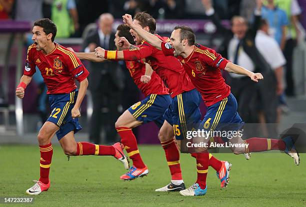 Jesus Navas, Sergio Ramos and Andres Iniesta of Spain celebrate the winning penalty during the UEFA EURO 2012 semi final match between Portugal and...
