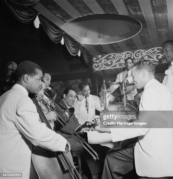 Portrait of Junior Raglin, Lawrence Brown, Johnny Hodges, Duke Ellington, Ray Nance, Sonny Greer, Fred Guy, and Harry Carney, Aquarium, New York,...