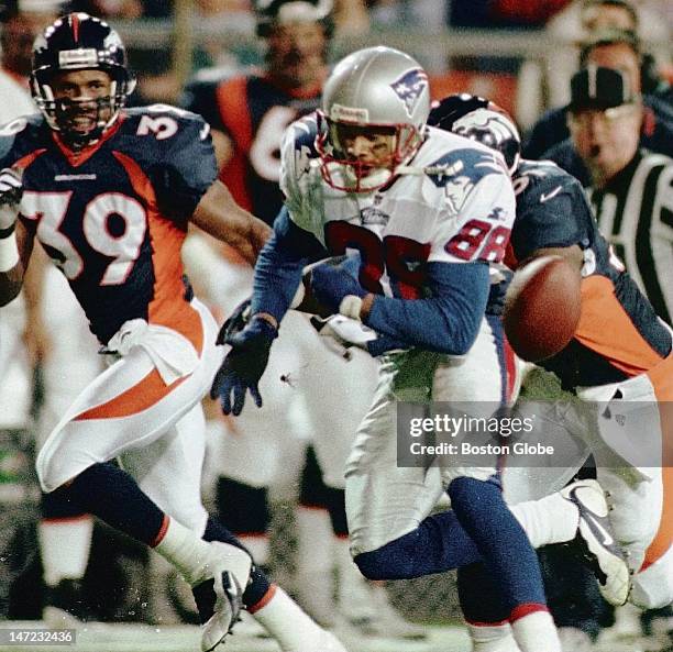 Patriots receiver Terry Glenn is stripped of the football by Denver linebacker John Mobley on New England's first possession of the game.