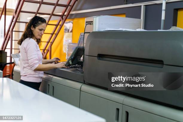 mature woman working in a printing press - computer printing stock pictures, royalty-free photos & images