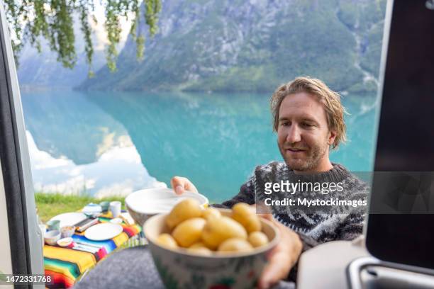 the van life, preparing diner by a beautiful lake on picnic table - norway food stock pictures, royalty-free photos & images