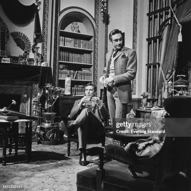 Actors Peter Finch and James Booth during the filming of 'The Trials of Oscar Wilde', March 31st, 1960.