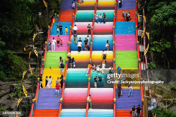 colorful steps all the way to the top of batu caves in kuala lumpur - indian art culture and entertainment stock pictures, royalty-free photos & images