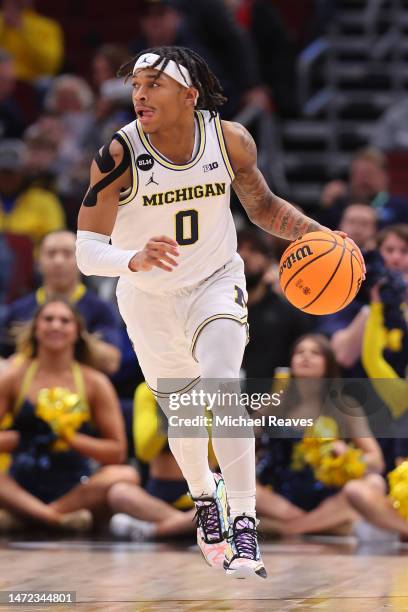 Dug McDaniel of the Michigan Wolverines dribbles against the Rutgers Scarlet Knights in the first half of the second round of the Big Ten Tournament...