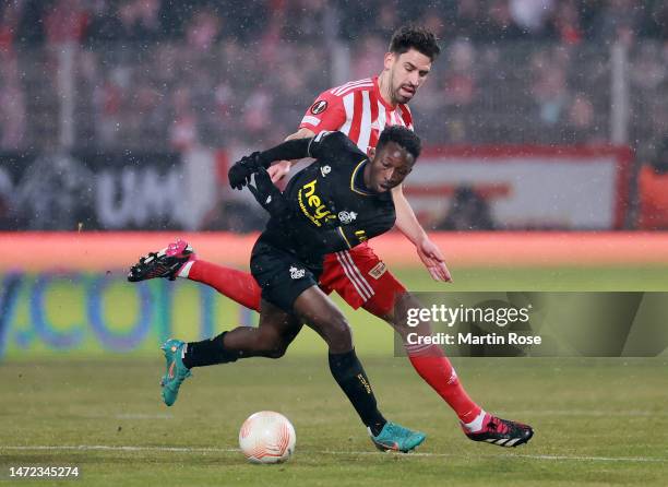 Lazare Amani of Royale Union Saint-Gilloise and Rani Khedira of 1.FC Union Berlin battle for the ball during the UEFA Europa League round of 16 leg...