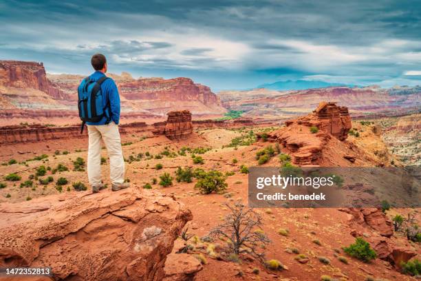 hiker capitol reef national park utah usa sunset point - capitol reef national park stock pictures, royalty-free photos & images