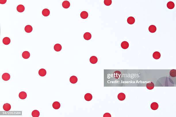 red dots on the white background - red polka dot stock pictures, royalty-free photos & images