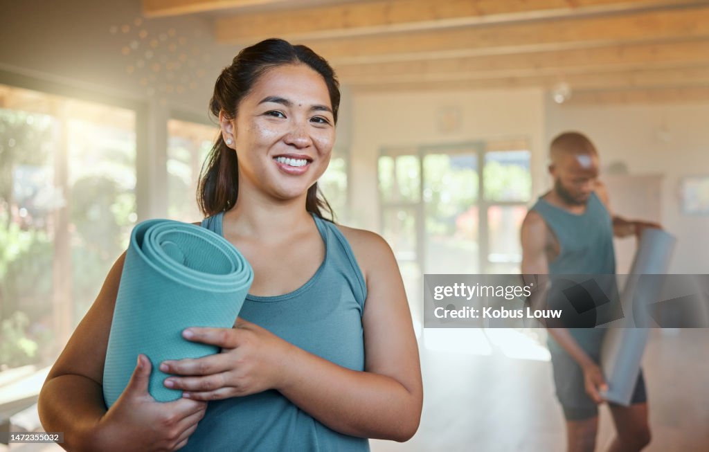 Ready, fitness and portrait of a woman at yoga, exercise or training with people at the gym. Health, sports and girl with a mat and smile to start pilates, cardio wellness or a workout at a gym