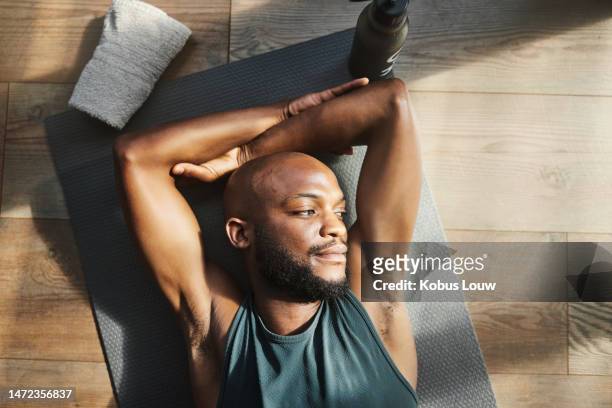 top view, fitness and black man tired, thinking and sunshine with morning routine, training and exercise.  african american male, athlete and guy on floor, resting and relax with ideas and wondering - practicing stock pictures, royalty-free photos & images