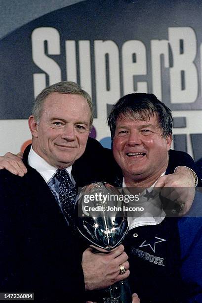 Super Bowl XXVIII: Dallas Cowboys owner Jerry Jones and head coach Jimmy Johnson victorious with Vince Lombardi Trophy in locker room after winning...