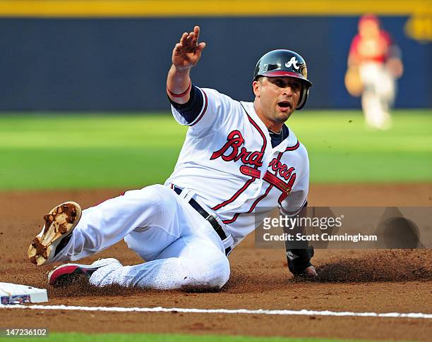 Martin Prado of the Atlanta Braves steals third base against the Arizona Diamondbacks at Turner Field on June 27, 2012 in Atlanta, Georgia.