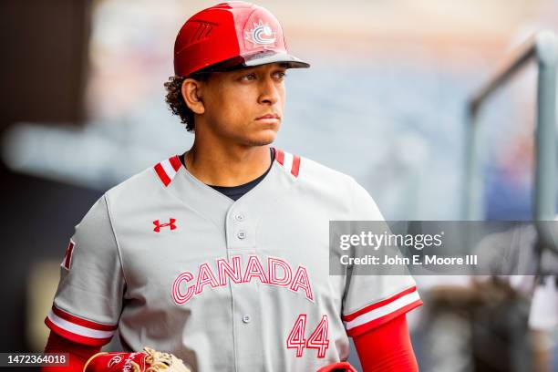 Bo Naylor of Team Canada walks through the dugout before a spring training exhibition game against the Seattle Mariners at Peoria Stadium on March...