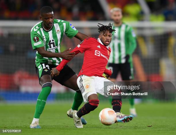 Fred of Manchester United is challenged by William Carvalho of Real Betis during the UEFA Europa League round of 16 leg one match between Manchester...