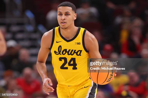 Kris Murray of the Iowa Hawkeyes dribbles against the Ohio State Buckeyes in the first half of the second round in the Big Ten Tournament at United...