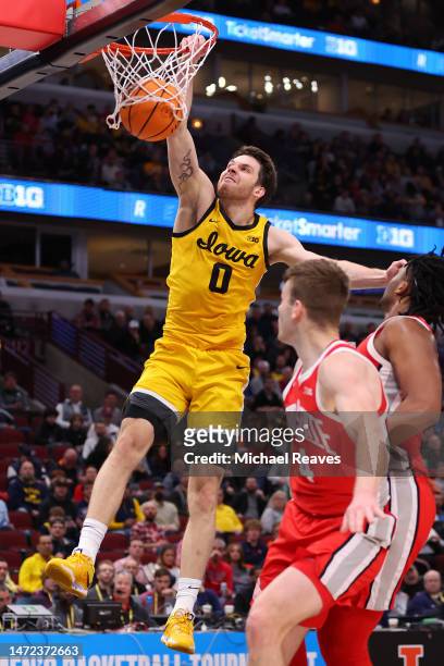 Filip Rebraca of the Iowa Hawkeyes dunks against the Ohio State Buckeyes in the first half of the second round in the Big Ten Tournament at United...