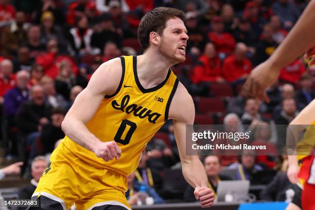 Filip Rebraca of the Iowa Hawkeyes celebrates a dunk against the Ohio State Buckeyes in the first half of the second round in the Big Ten Tournament...