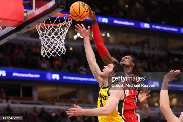 Filip Rebraca of the Iowa Hawkeyes shot is blocked by Felix Okpara of the Ohio State Buckeyes in the first half of the second round in the Big Ten...