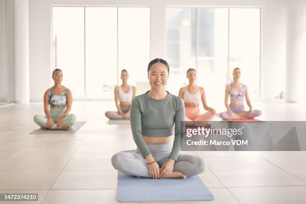 woman, asian and portrait with for yoga lotus for workout, exercise and wellness in gym with group. happy gen z girl, personal trainer and happiness on floor, blurred background and body health goal - yoga props stock pictures, royalty-free photos & images